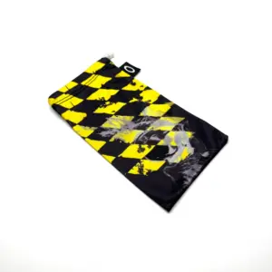 Funda de microfibra para gafas Oakley con estampado de cuadros amarillos y negros, diseño de calavera difuminada y etiqueta de marca en el borde superior.