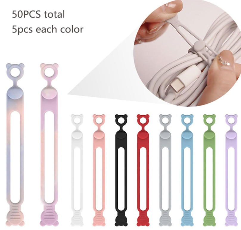 Sujetadores de silicona con diseño de oso para cables en colores sólidos y degradados. Set de 50 piezas en 10 tonos, organizando un cable USB.