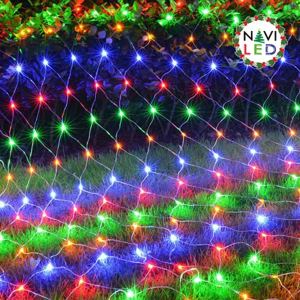 Malla de luces LED multicolor de 1.2x1 metro desplegada sobre arbustos y césped con iluminación brillante navideña.
