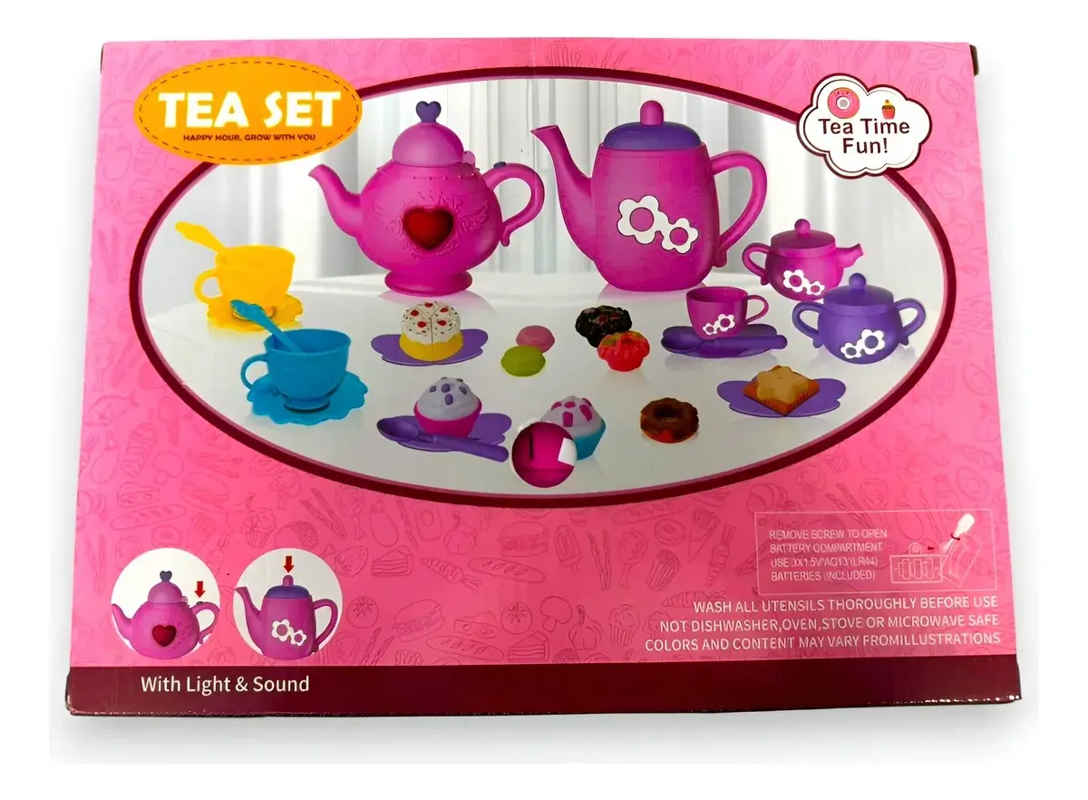 Caja rosa con set de té infantil de juguete, incluye dos teteras, tazas, platillos, postres y cucharas sobre superficie blanca.