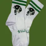 Par de medias blancas de media caña con dos líneas verdes, diseño de Buttercup y la marca Bellis impresa en verde sobre la zona acolchada del empeine