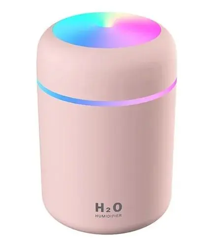 Humidificador aromatizador de aire rosa pastel con diseño cilíndrico y luces LED RGB en la parte superior y un anillo luminoso central.