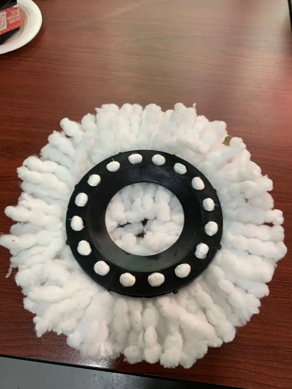 Repuesto de mopa 360 de microfibra blanca con base circular negra, vista superior sobre superficie de madera.