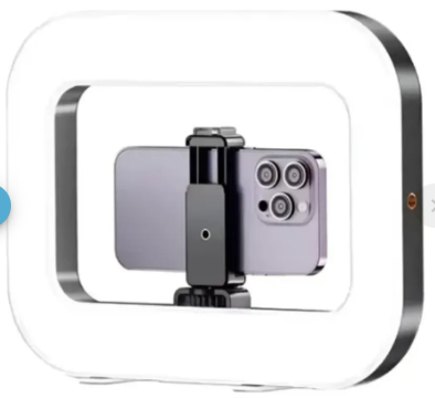 Aro de luz rectangular RGB con soporte central para celular, diseño compacto en color negro y blanco para iluminación uniforme en creación de contenido.