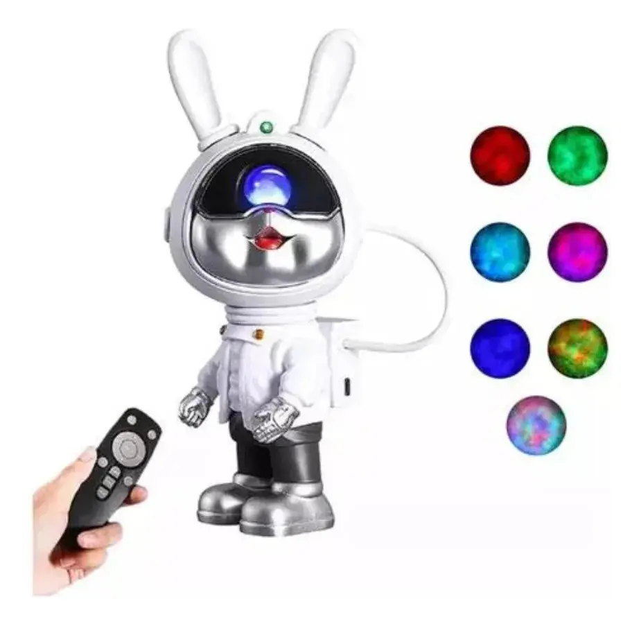 Proyector de galaxias con astronauta conejo blanco y plateado, incluye control remoto y muestra siete colores de luz cósmica.