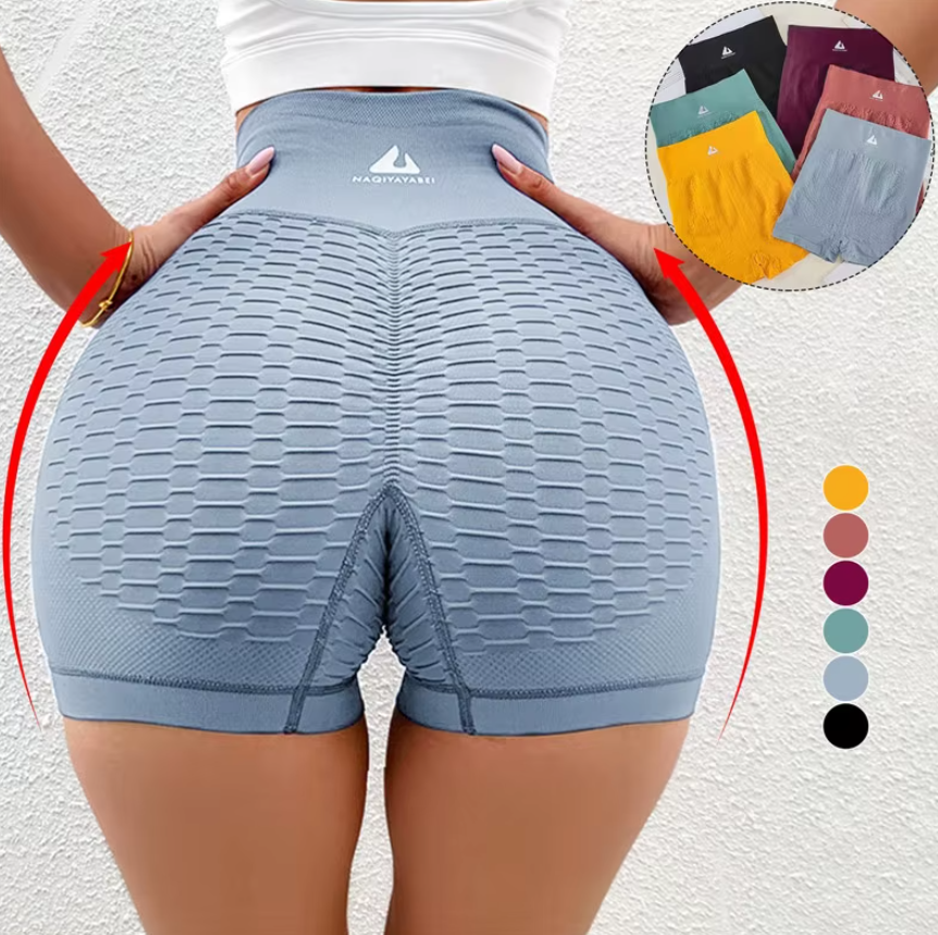Short de lycra deportiva push-up azul grisáceo de cintura alta con textura de panal, realce en glúteos y variante de color disponible.