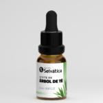 Aceite de Árbol de Té Pasión Selvática en frasco ámbar con gotero negro, etiqueta blanca con motivos verdes y presentación de 25 ml.