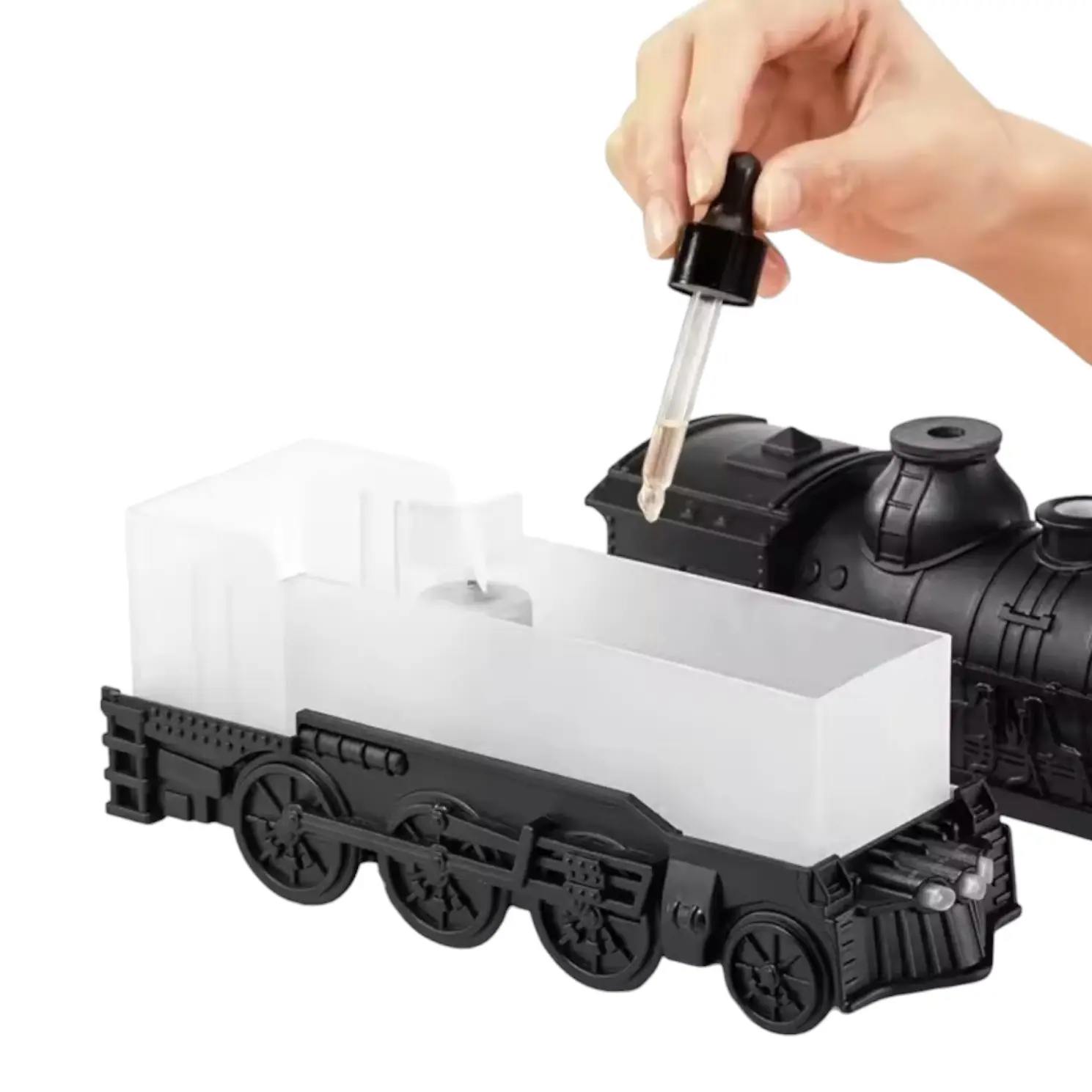 Tren humidificador negro de 300 ml con tanque transparente y una mano agregando agua con gotero para vapor LED.