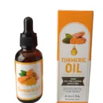 Frasco de vidrio ámbar con gotero junto a su caja naranja de aceite de cúrcuma de 30ml, diseñado para el cuidado y tratamiento de manchas en piel.