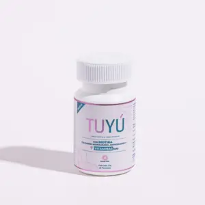 Frasco blanco de vitaminas Tuyú con etiqueta en tonos rosados y azules, formulado con biotina y colágeno para el fortalecimiento capilar.