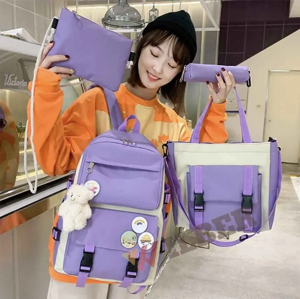 Set morral escolar morado 5 en 1 de oxford con mochila, bolso de mano, estuche, cartuchera y osito colgante organizados para estudiar.