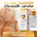 Mujer con toalla en la cabeza aplica aceite corporal hidratante Truly Vanilla Baby sobre fondo dorado
