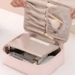 Cosmetiquera impermeable rosa abierta, con compartimento superior para pinceles, solapa transparente y estuche organizador interno con cremallera.