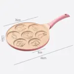 Sartén antiadherente rosa de 26 cm con 7 moldes de animales para panqueques, 1.3 cm de profundidad y 46 cm de largo total, ideal para desayunos infantiles.