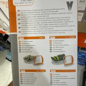 Caja vertical blanca y naranja de cortador Nicer Quick; muestra ilustraciones de 4 accesorios naranjas de corte con medidas de 5 mm y 10 mm.