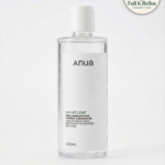 Envase cilíndrico transparente de 200ml con limpiador facial Anua Heartleaf Pore Cleansing Oil, etiqueta blanca minimalista y tapa dosificadora blanca.
