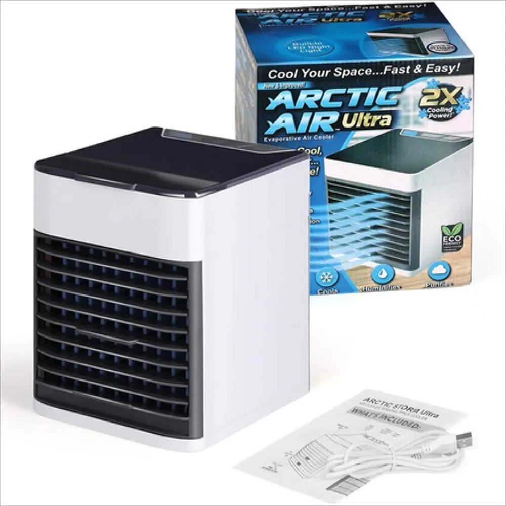 Enfriador de aire personal blanco con rejillas negras, caja del producto, cable USB y manual sobre superficie blanca.