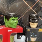 Tres pocillos de cerámica 3D con forma de Hulk, Batman y Iron Man, exhibidos sobre sus cajas originales, incluyendo una de 16 onzas de Batman.