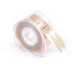 Dispensador transparente con rollo de tiras adhesivas para párpados color piel, de forma ovalada y textura mate para efecto lifting.