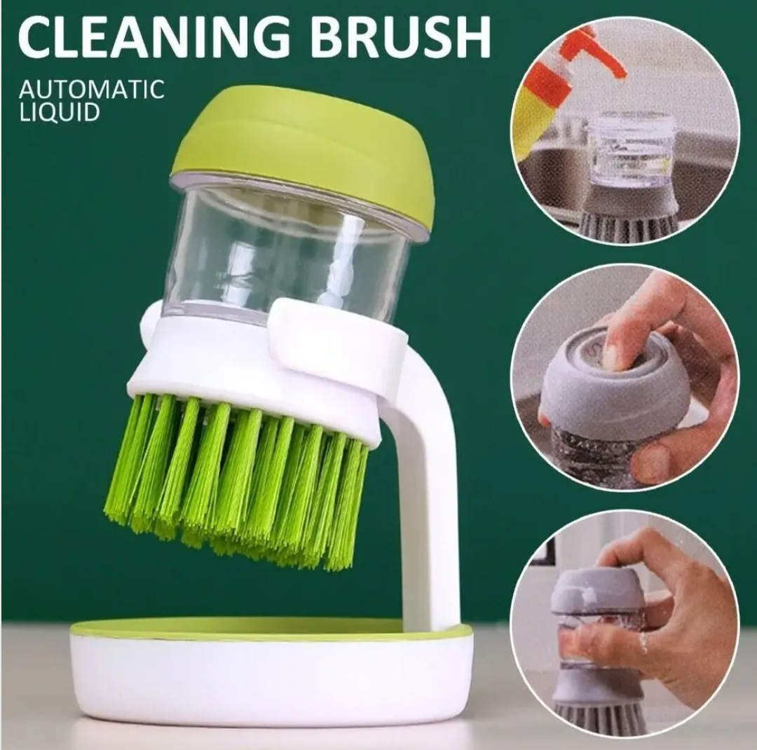 Cepillo fregador verde y blanco con dispensador de jabón, cerdas plásticas y base de soporte, ideal para lavar platos.