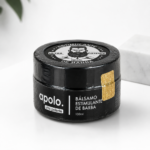 Bálsamo estimulante para barba Apolo ultra potente de 100ml en envase negro con tapa ilustrada y sello dorado, sobre fondo blanco.
