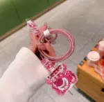 Cable de carga con protector flexible color rosa y apliques decorativos de Lotso, con textura espiral brillante y diseño temático de Toy Story.