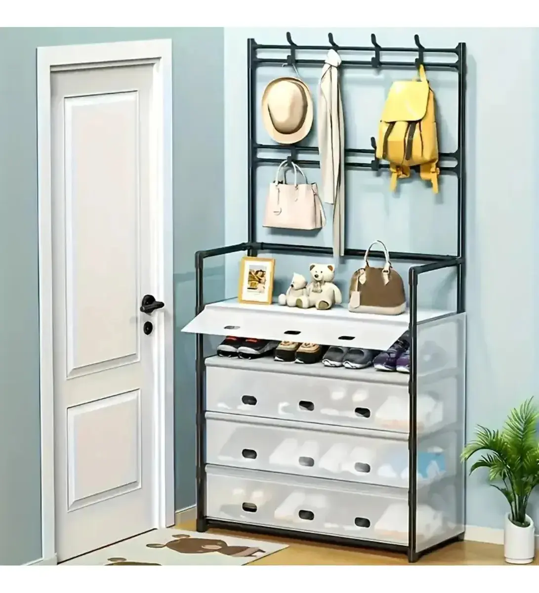 Zapatero organizador metálico con perchero superior de pared, cuatro cajones translúcidos blancos y balda central con dos osos de peluche.
