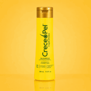 Shampoo Crecepel anticaída y crecimiento en envase amarillo de 350 ml con tapa dorada, sobre fondo amarillo con reflejo inferior.