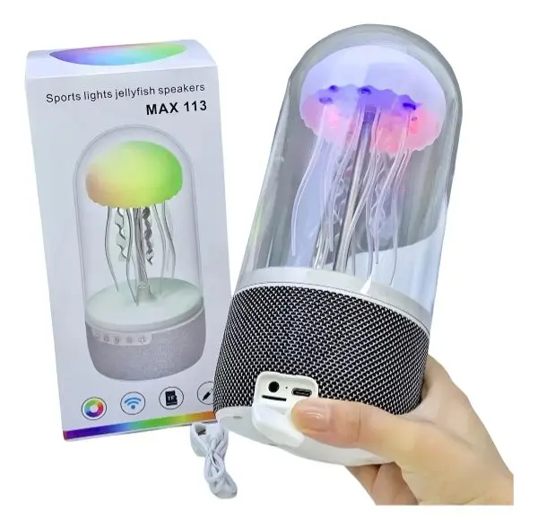 Parlante bluetooth tipo lámpara de medusa con cúpula transparente, base de tela negra y caja de empaque con referencia MAX 113.