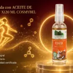 Botella de aceite de coco spray x120 ml sobre podio luminoso con fondo dorado, ideal para uso cosmético y bienestar diario.